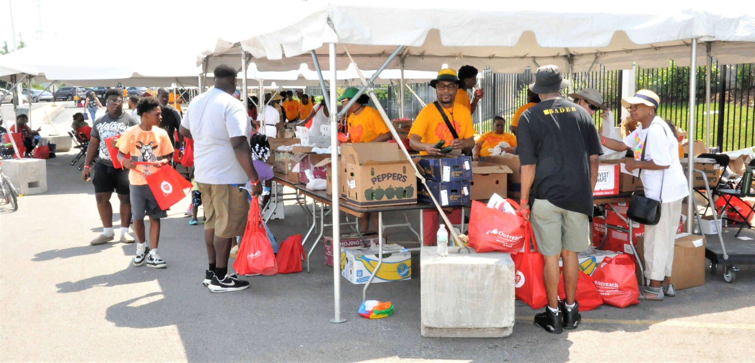 Community health fair with tents and volunteers